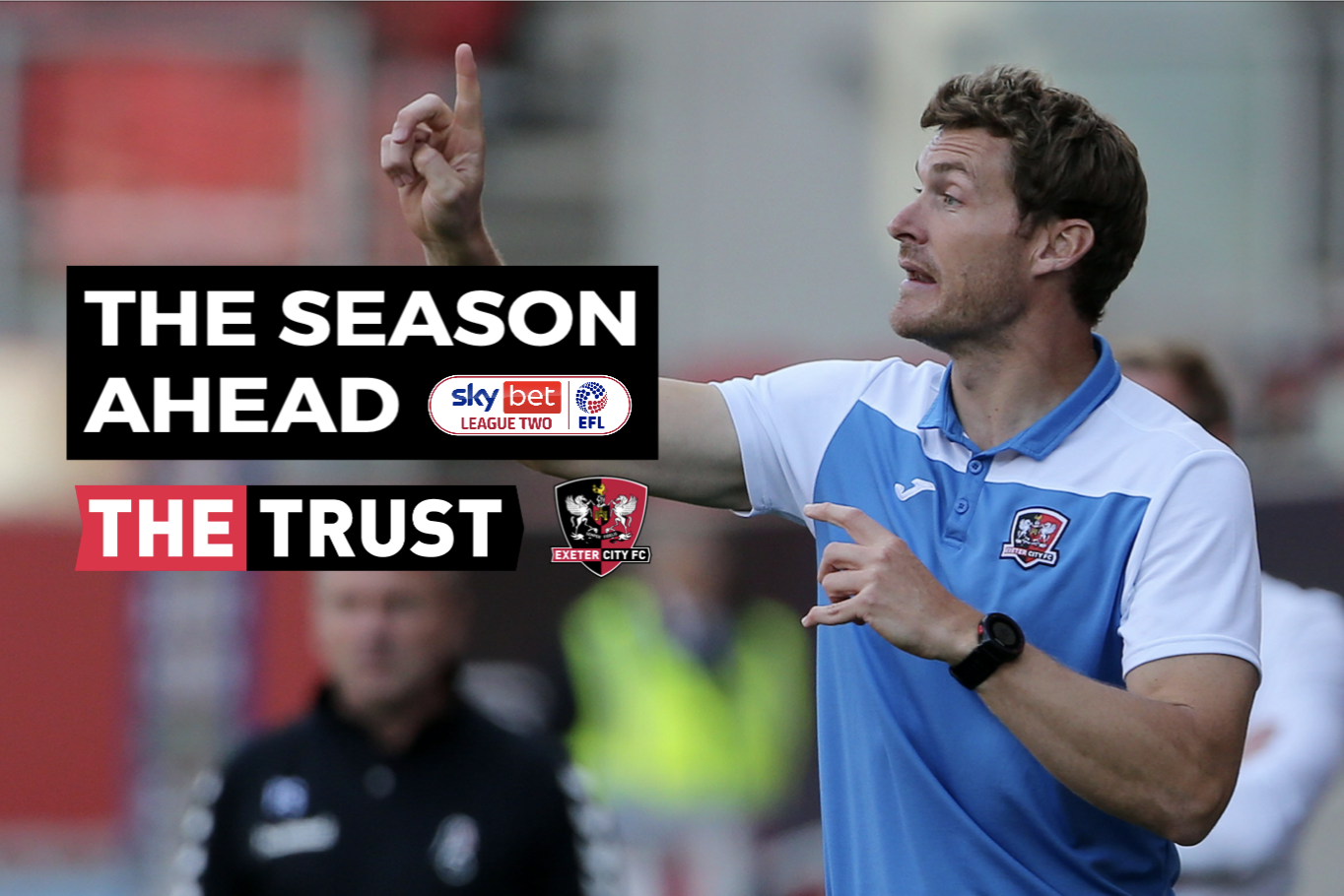 Matt Taylor instructs his players, with the words 'The Season Ahead' and the Supporters' Trust and football club logos superimposed.